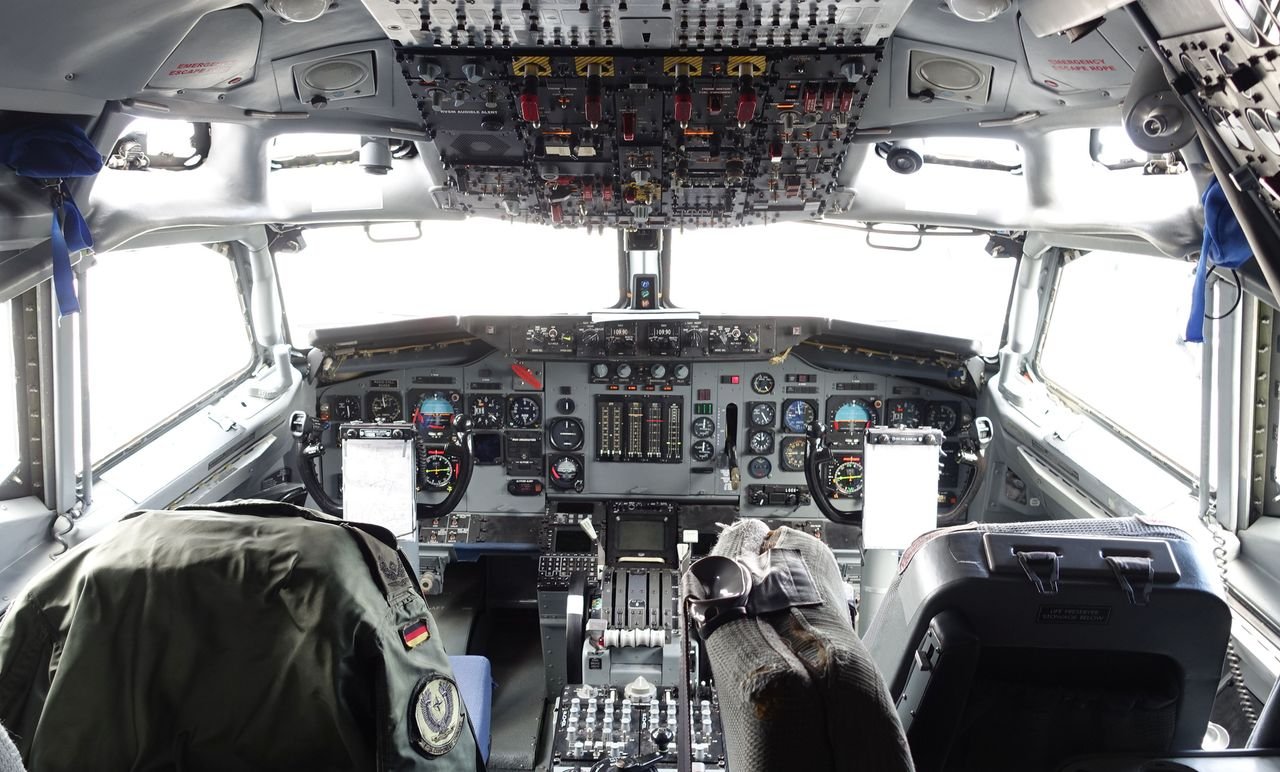 Explore the intricate aircraft cockpit, showcasing aviation controls and design.